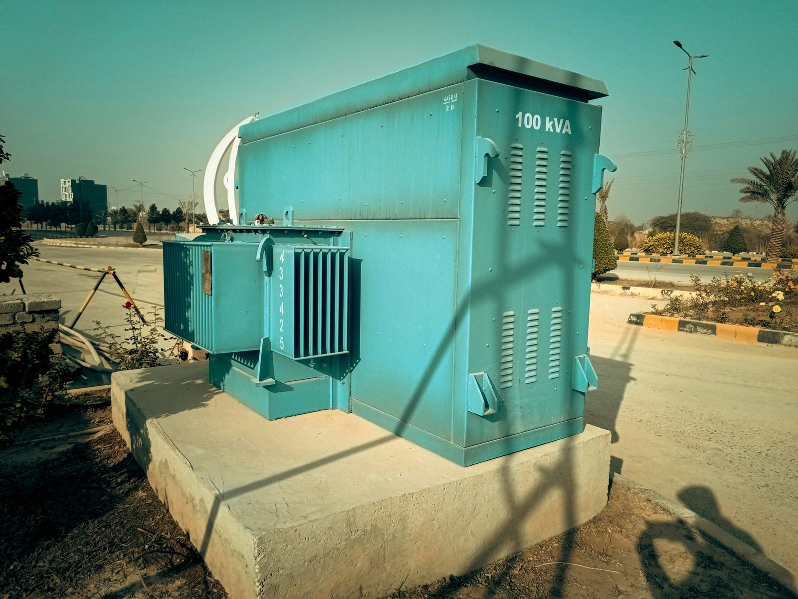 a large blue box sitting on the side of a road